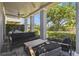 Inviting covered patio featuring sleek outdoor seating and charming views of the manicured yard at 7523 Excitement Dr, Kissimmee, FL 34747