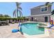 Private backyard pool and spa area with lounge seating and a basketball hoop at 7523 Excitement Dr, Kissimmee, FL 34747