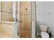 Shower features tiled walls, glass door, and updated showerhead at 7523 Excitement Dr, Kissimmee, FL 34747