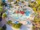 Aerial view of water park with slides, palm trees, lounge chairs, umbrellas and water at 7523 Excitement Dr, Kissimmee, FL 34747