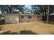 View of the home's rear elevation and partially fenced yard showing window views from the exterior at 5222 Montague Pl, Orlando, FL 32808