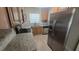 Modern kitchen boasts stainless steel appliances, granite countertops, and a stylish tile backsplash at 5222 Montague Pl, Orlando, FL 32808