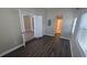 An open-concept living room featuring newly installed dark wood flooring and neutral paint throughout at 5222 Montague Pl, Orlando, FL 32808