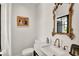 Tasteful powder room with a marble sink, a gold ornate mirror, and a charming aesthetic at 740 Oak Shadows Rd, Kissimmee, FL 34747
