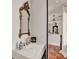 Powder room featuring an ornate gold mirror and a white marble countertop with stylish fixtures and a modern aesthetic at 740 Oak Shadows Rd, Kissimmee, FL 34747
