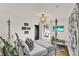 Bright bedroom showcasing a four-poster bed, TV, artistic elements, and natural light at 740 Oak Shadows Rd, Kissimmee, FL 34747