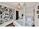 Bedroom with four-poster bed and modern artwork, open doorway, and modern lighting at 740 Oak Shadows Rd, Kissimmee, FL 34747