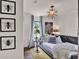 Bedroom with modern decor, artwork, and natural light from a window at 740 Oak Shadows Rd, Kissimmee, FL 34747