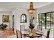 Bright dining room showcasing a round table, chandelier, and large windows overlooking the exterior at 740 Oak Shadows Rd, Kissimmee, FL 34747