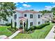 Stunning two-story home with red tile roof, lush landscaping, and a covered entry at 740 Oak Shadows Rd, Kissimmee, FL 34747