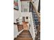 Foyer featuring hardwood floors, tiled staircase, wrought iron railing, and staircase at 740 Oak Shadows Rd, Kissimmee, FL 34747