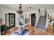 A welcoming foyer showcasing tile stairs, unique light fixture and decorative doorway at 740 Oak Shadows Rd, Kissimmee, FL 34747
