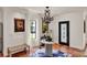 Welcoming foyer with tile floors, decorative light fixture, and iron and glass front door at 740 Oak Shadows Rd, Kissimmee, FL 34747