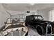 Clean garage featuring two luxury vehicles, including a black G-Wagon, and a utility vehicle with a white and tan camo pattern at 740 Oak Shadows Rd, Kissimmee, FL 34747