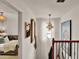 Staircase landing with artwork and an ornate mirror that leads to a bedroom at 740 Oak Shadows Rd, Kissimmee, FL 34747
