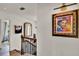 Upstairs landing featuring decorative art pieces and wrought iron railing on wood staircase at 740 Oak Shadows Rd, Kissimmee, FL 34747