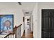 Upstairs hallway with hardwood floors, accent paintings, black doors and wrought iron railing at 740 Oak Shadows Rd, Kissimmee, FL 34747