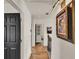 Hallway with hardwood flooring and decorative art that leads to the staircase at 740 Oak Shadows Rd, Kissimmee, FL 34747
