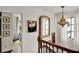 Hallway with decorative artwork and a staircase with wooden railings at 740 Oak Shadows Rd, Kissimmee, FL 34747