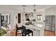 Kitchen island with seating, chandelier lighting, stainless appliances, and modern design at 740 Oak Shadows Rd, Kissimmee, FL 34747