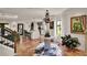 Open-concept living room features terra cotta floors, statement chandelier and seamlessly connects to the kitchen at 740 Oak Shadows Rd, Kissimmee, FL 34747