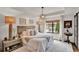 Serene bedroom with tray ceiling, starburst chandelier, and large window providing ample natural light at 740 Oak Shadows Rd, Kissimmee, FL 34747