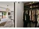 Walk-in closet connected to a bedroom featuring custom shelving for storage at 740 Oak Shadows Rd, Kissimmee, FL 34747