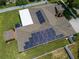 Aerial view of house featuring solar panels on roof and well-maintained lawn and white fenced in backyard at 790 Country Charm Cir, Oviedo, FL 32765