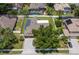 Aerial view of a home with a well-manicured lawn, solar panels and fenced yard at 790 Country Charm Cir, Oviedo, FL 32765