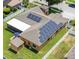 Aerial view showcasing the fenced backyard, screened in patio and solar panels that ensure energy efficiency at 790 Country Charm Cir, Oviedo, FL 32765