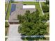Aerial view of a home with solar panels, a large backyard and mature trees at 790 Country Charm Cir, Oviedo, FL 32765