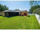Large backyard features a screened lanai, patio, shed, and manicured lawn at 790 Country Charm Cir, Oviedo, FL 32765
