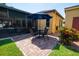 Backyard patio with black wrought iron seating under a blue umbrella at 790 Country Charm Cir, Oviedo, FL 32765