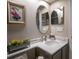 Powder room with updated vanity, granite countertop, decorative mirrors and stylish fixtures at 790 Country Charm Cir, Oviedo, FL 32765