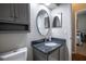 Bathroom with granite countertop, oval mirror, cabinet and toilet at 790 Country Charm Cir, Oviedo, FL 32765