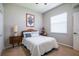 Neutral bedroom with a queen bed, simple decor, and lots of natural light at 790 Country Charm Cir, Oviedo, FL 32765