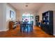 Bright dining room with hardwood floors, a large window, and a modern light fixture at 790 Country Charm Cir, Oviedo, FL 32765