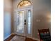Beautiful front door featuring decorative glass panels with matching transom window above letting in natural light at 790 Country Charm Cir, Oviedo, FL 32765