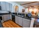 Kitchen showcasing dark granite countertops, gray cabinets, and wood-look flooring at 790 Country Charm Cir, Oviedo, FL 32765