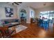 Open living area with wood floors, comfortable seating, and an adjacent dining area at 790 Country Charm Cir, Oviedo, FL 32765