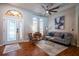 Comfortable living room featuring hardwood floors, neutral walls, and a stylish ceiling fan at 790 Country Charm Cir, Oviedo, FL 32765