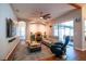 Living room with ceiling fan, modern furniture, area rug, and wood-look flooring at 790 Country Charm Cir, Oviedo, FL 32765