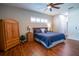Spacious main bedroom featuring hardwood floors, neutral walls, and a ceiling fan at 790 Country Charm Cir, Oviedo, FL 32765