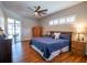 Spacious main bedroom featuring hardwood floors, a ceiling fan, and access to screened patio at 790 Country Charm Cir, Oviedo, FL 32765