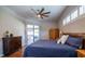 Main bedroom with hardwood floors, ceiling fan, and access to the outdoor patio at 790 Country Charm Cir, Oviedo, FL 32765
