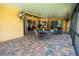 The covered patio has brick pavers and multiple seating arrangements at 790 Country Charm Cir, Oviedo, FL 32765