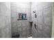 Tiled shower with rainfall showerhead and recessed shelving niche at 790 Country Charm Cir, Oviedo, FL 32765