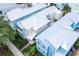 An aerial view of colorful coastal-style homes featuring lush landscaping and white metal roofs at 1430 Reunion Blvd, Reunion, FL 34747