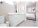 Bright bathroom featuring a modern white vanity and easy access to the nearby bedroom at 1430 Reunion Blvd, Reunion, FL 34747