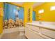 Bathroom featuring a minion themed shower curtain and a white countertop vanity at 1430 Reunion Blvd, Reunion, FL 34747